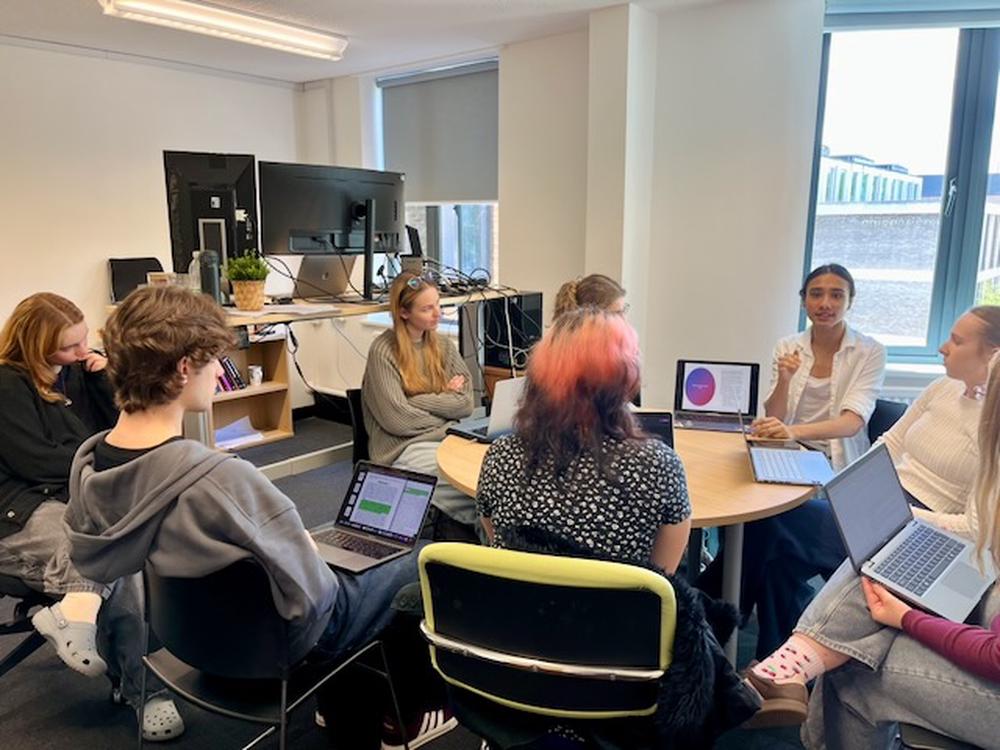 LISN lab members discussing research around a table